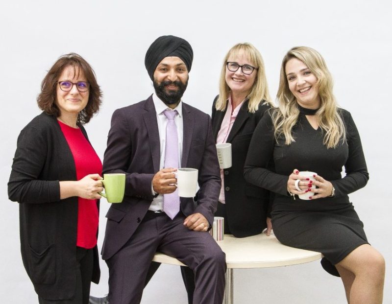 Members of staff with coffee cups